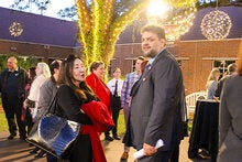 Photo of Rabieh Razzouk outdoors speaking with a woman at an LSI banquet.