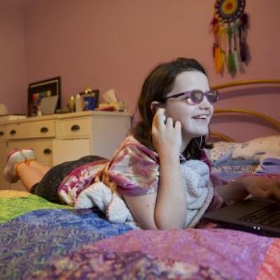 A sixth-grade student turns up the volume as she attends class through the digital academy at the The School of Arts and Sciences on Thomasville Road. (Courtesy of Robert Schoen)