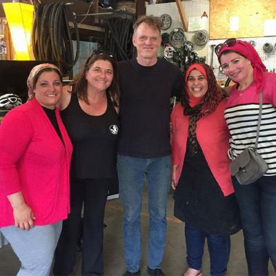 Cyndi Harlow poses with a group of women from Egypt before a bike ride through the Cascades.