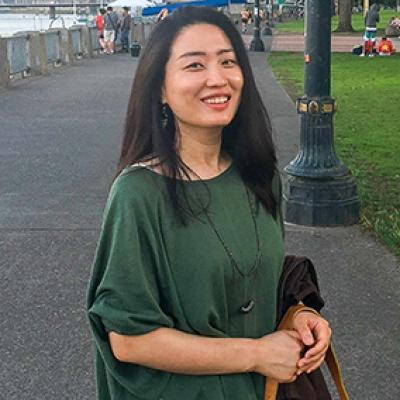 Dr. Kim posing outdoors.