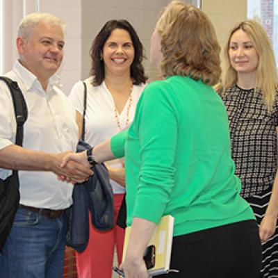 Dr. Adrii Paziuk meets Michelle Kazmer, dean of the College of Communication and Information. Dr. Vilma Fuentes and Anna Romanova are with him.