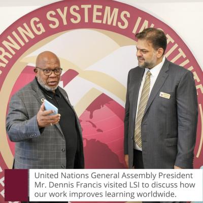Photo of UN General Assembly President Dennis Francis and LSI Director Rabieh Razzouk in front of a large LSI logo banner. 