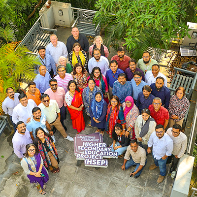Group photo taken from above of a group in Bangladesh posing for a photo.