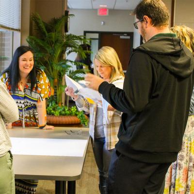 Group working together in a room on the FSU campus writing assessment questions. 