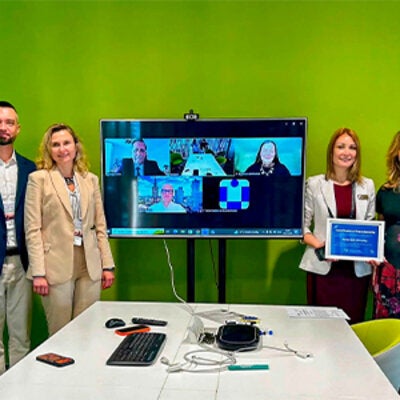 Dr. Anna Romanova standing with a group at a conference in Lviv, Ukraine.