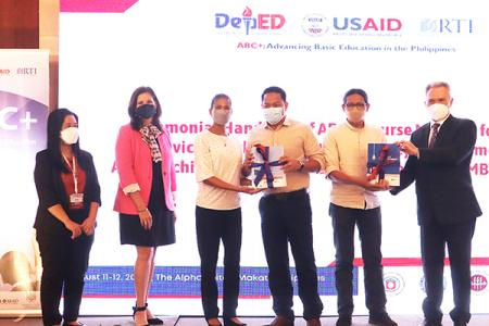 Group photo on a stage during a materials handover ceremony on the ABC+ Philippines project.