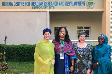 Four women posing for a photo outside of the Nigerian Center for Reading Research and Development