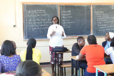 Teacher standing in front of a classroom of for a teacher training.