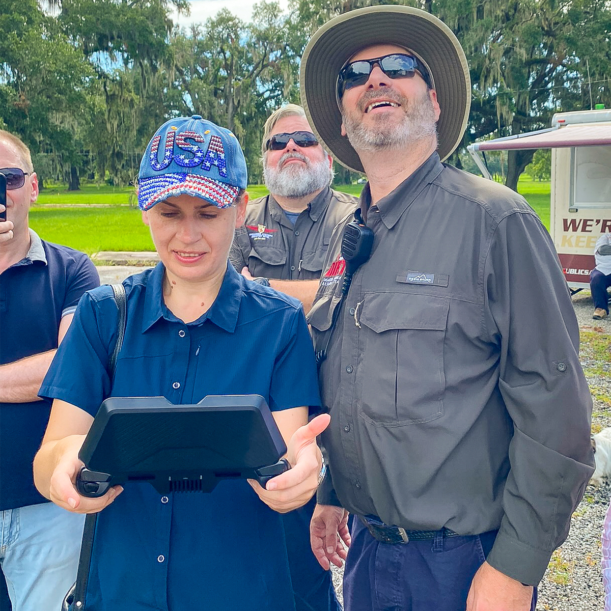 "Dr. Nataliia Safonova holding a control panel for a drone next to an instructor"