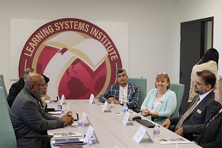 "Bhushan Dahal meeting with a group featuring he President of the UN General Assembly"