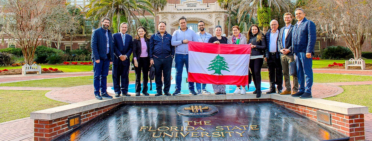 "Group holding the flag of Lebanon while posing for a photo at FSU's Westcott fountain."